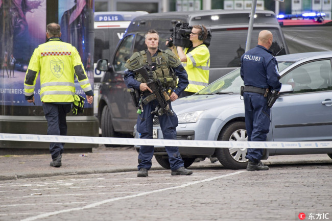 Police officers gather at the site of a multiple stabbing on the Market Square in Turku, Finland, 18 August 2017. [Photo: IC]