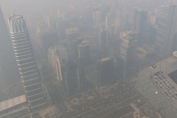 A file photo taken on Dec. 17, 2016 shows buildings enveloped in smog in Beijing. [Photo: Xinhua/Jin Liangkuai]