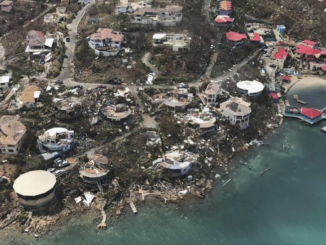 This photo provided on Friday, Sept. 8, 2017, shows storm damage in the aftermath of Hurricane Irma in Virgin Gorda's Leverick Bay in the British Virgin Islands. Irma scraped Cuba's northern coast Friday on a course toward Florida, leaving in its wake a ravaged string of Caribbean resort islands strewn with splintered lumber, corrugated metal and broken concrete. [Photo: AP/Caribbean Buzz Helicopters]
