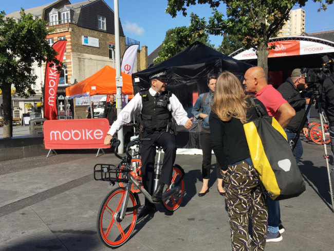Locals try out the Mobikes, which are released in the west London borough of Ealing, on Tuesday, September 12, 2017. 