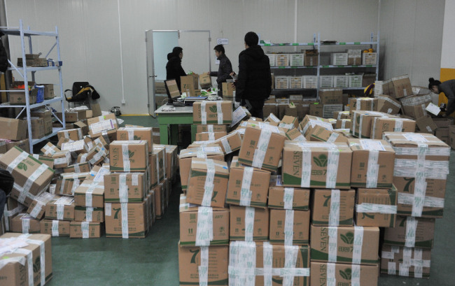Packages are stocking in a delivery company in Zhejiang, ready to be delivered. [Photo: meldingcloud.com.cn]