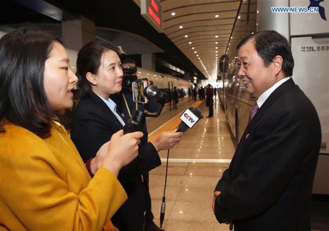 Wu Xie'en (R), a delegate of Jiangsu Province to the 19th National Congress of the Communist Party of China (CPC), receives an interview upon his arrival in Beijing, capital of China, Oct. 16, 2017. Delegates of Jiangsu Province to the 19th CPC National Congress arrived in Beijing on Monday. The congress will start on Oct. 18 in Beijing. [Photo: Xinhua]