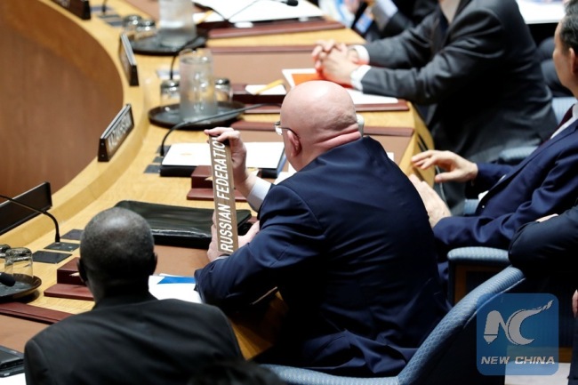 Russian ambassador to the United Nations Vassily Nebenzia, holds up the Russian Federation name plate demanding to speak during a Security Council meeting at the UN headquarters in New York, Oct. 24, 2017. [Photo: Xinhua]