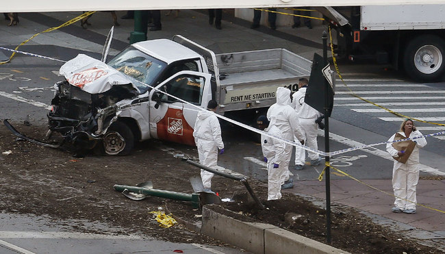 Authorities stand near a damaged Home Depot truck after a motorist drove onto a bike path near the World Trade Center memorial, striking and killing several people Tuesday, Oct. 31, 2017, in New York. [Photo: AP]