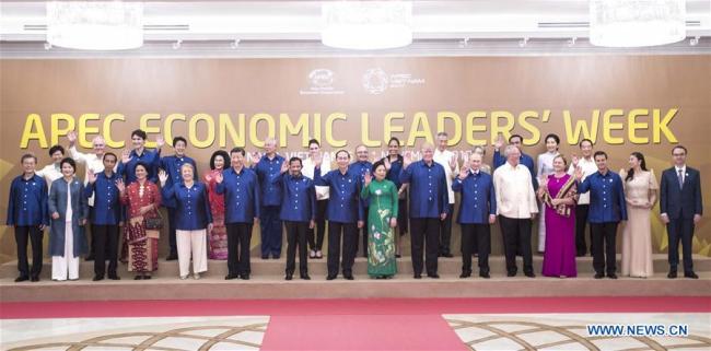Chinese President Xi Jinping (6th L, front) poses for a family photo before a gala dinner hosted by Vietnamese President Tran Dai Quang and his wife for leaders, delegates and spouses attending the 25th Asia-Pacific Economic Cooperation (APEC) Economic Leaders' Meeting, in Da Nang, Vietnam, Nov. 10, 2017. [Photo: Xinhua]