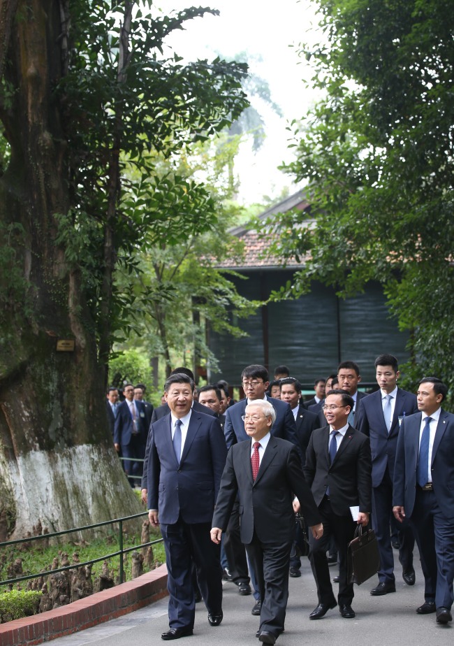 Visiting Chinese President Xi Jinping, who is also general secretary of the Communist Party of China (CPC) Central Committee, and Nguyen Phu Trong, General Secretary of the Communist Party of Vietnam (CPV) Central Committee, go for a stroll at the former residence of late Vietnamese leader Ho Chi Minh in Hanoi, Vietnam, November 13, 2017. [Photo: Xinhua/Yao Dawei] 