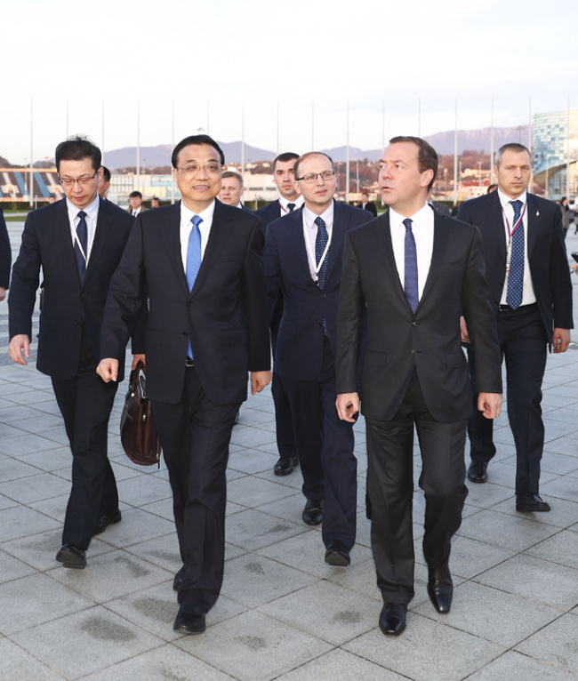 Chinese Premier Li Keqiang, along with his Russian counterpart Dmitry Medvedev visit the Olympic stadium area located on the outskirts of Russia's coastal city of Sochi on Friday. [Photo: Xinhua]