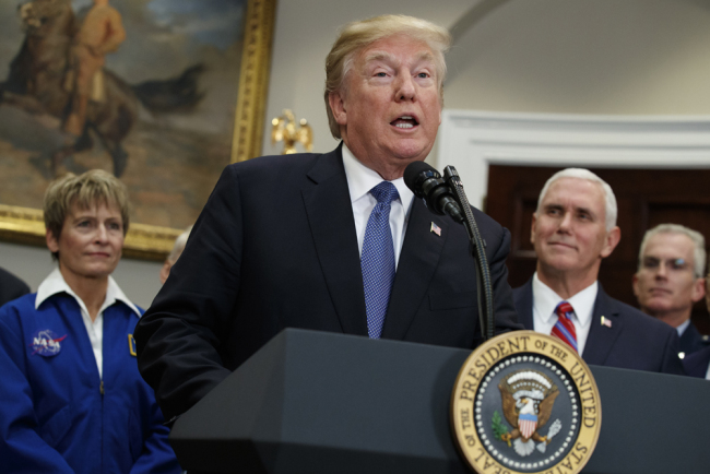 U.S. President Donald Trump speaks before signing a policy directive to send American astronauts back to the moon, and eventually Mars, in the Roosevelt Room of the White House, Dec. 11, 2017, in Washington. From left, NASA astronaut Peggy Whitson, Trump, Vice President Mike Pence, and Vice Chairman of the Joint Chiefs of Staff Gen. Paul J. Selva. [Photo: AP/Evan Vucci]