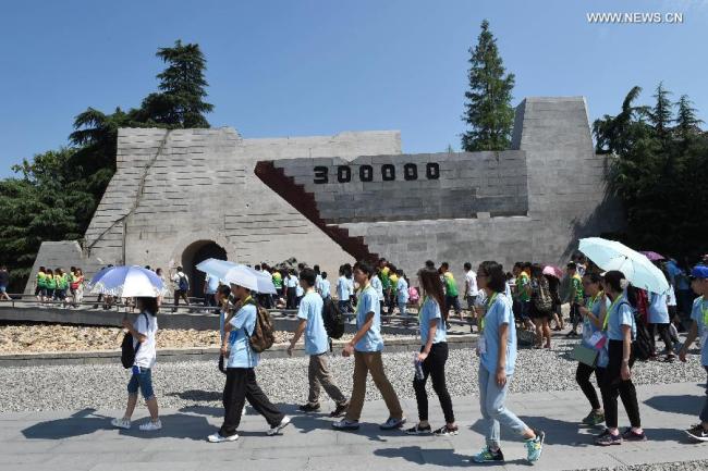 Students visit the Memorial Hall of the Victims in Nanjing Massacre by Japanese Invaders in Nanjing, capital of east China's Jiangsu Province, July 29, 2015. [Photo: Xinhua]