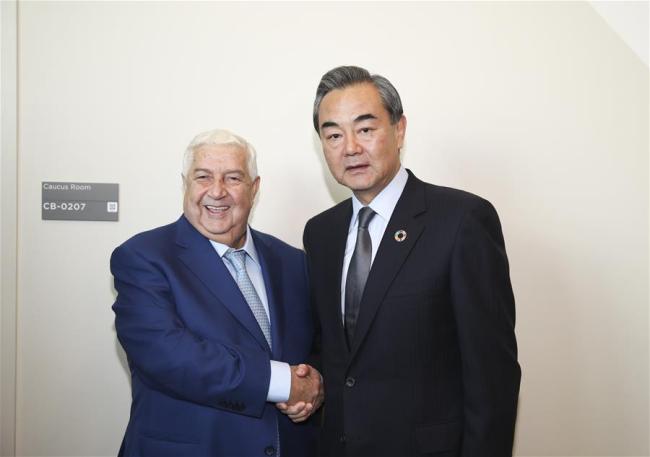 Chinese Foreign Minister Wang Yi (R) shakes hands with Syrian Deputy Prime Minister and Foreign Minister Walid Muallem during their meeting at the UN headquarters in New York, on Sept. 22, 2017.[Photo: Xinhua]