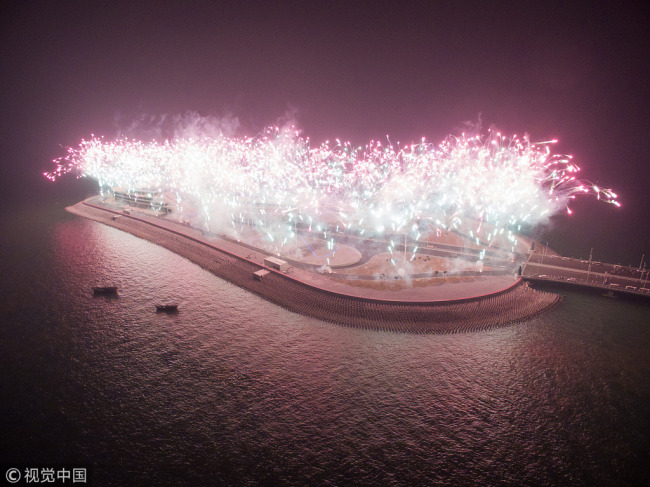 A fireworks display has accompanied the lighting ceremony of the Hong Kong-Zhuhai-Macao Bridge on Sunday, December 31, 2017. Major work on the bridge has now been completed, which includes a 22.9-kilometer-long main bridge, a 6.7-kilometer-long tunnel and an artificial island off the bridge, the creation of which is considered the most technically demanding part of the construction. [Photo: VCG]