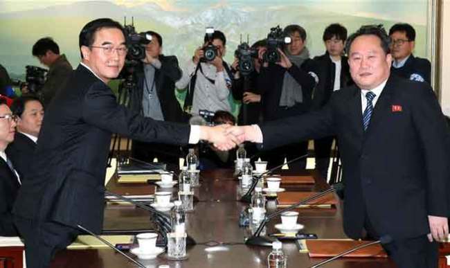Ri Son-gwon (R), chairman of the Committee for the Peaceful Reunification of the Fatherland of the Democratic People's Republic of Korea (DPRK), shakes hands with South Korean Unification Minister Cho Myoung-gyon in the truce village of Panmunjom, Jan. 9, 2018. South Korea and the DPRK on Tuesday kicked off a senior-level, inter-governmental dialogue in the truce village of Panmunjom. [Photo: Xinhua]