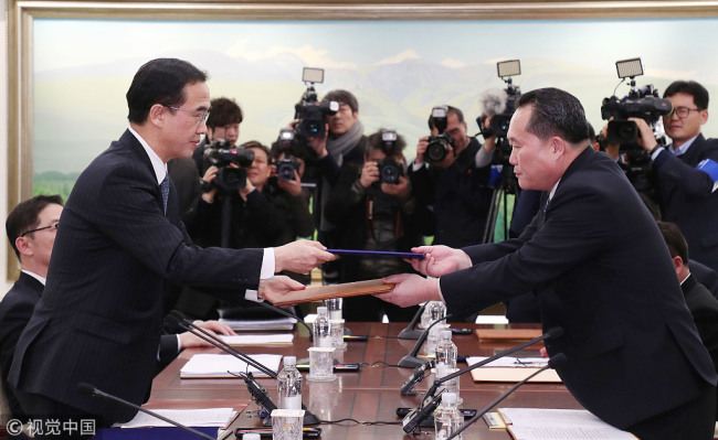 Ri Son-gwon (R), chairman of the Committee for the Peaceful Reunification of the Fatherland of the Democratic People's Republic of Korea (DPRK), shakes hands with South Korean Unification Minister Cho Myoung-gyon in the truce village of Panmunjom, Jan. 9, 2018. South Korea and the DPRK on Tuesday kicked off a senior-level, inter-governmental dialogue in the truce village of Panmunjom. [Photo: VCG]