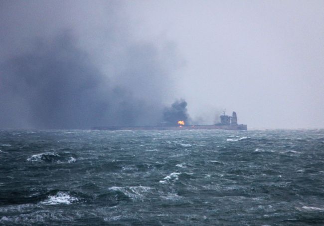 Handout photo from January 9, 2018 from China's Transport Ministry shows smoke and flames coming from the burning oil tanker 'Sanchi' off China's east coast. Chinese authorities say major oil spill has been detected due to the nature of the oil it was carrying. However, 31 sailors remain missing. [Photo: VCG]