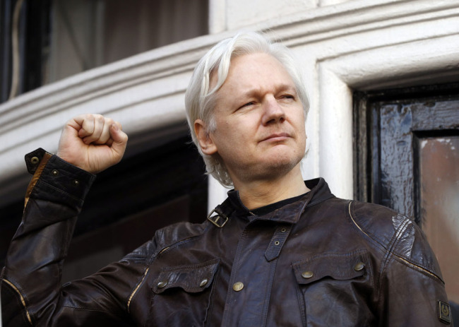 In this May 19, 2017 file photo, Julian Assange greets supporters outside the Ecuadorian embassy in London. [Photo: AP/Frank Augstein]