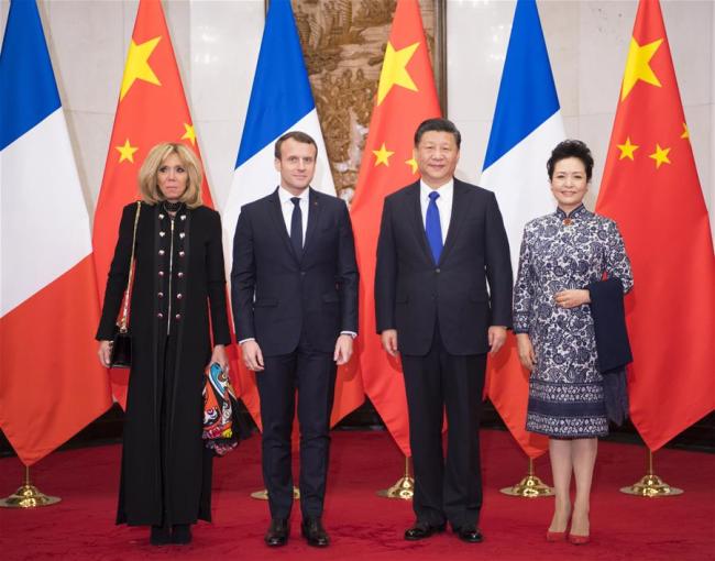 Chinese President Xi Jinping (2nd R) and his wife Peng Liyuan (1st R) pose for a group photo with visiting French President Emmanuel Macron (2nd L) and his wife Brigitte Macron at the Diaoyutai State Guesthouse in Beijing, capital of China, Jan. 8, 2018. Xi met with Macron in Beijing on Monday. [Photo: Xinhua]