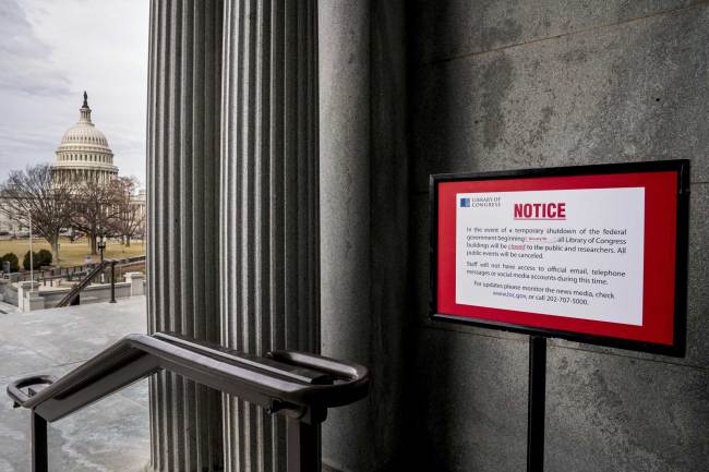 The dome of the Capitol Building is visible at left of a closure sign that is posted outside of the Library of Congress during a government shutdown in Washington, Monday, Jan. 22, 2018. [Photo: AP/Andrew Harnik]