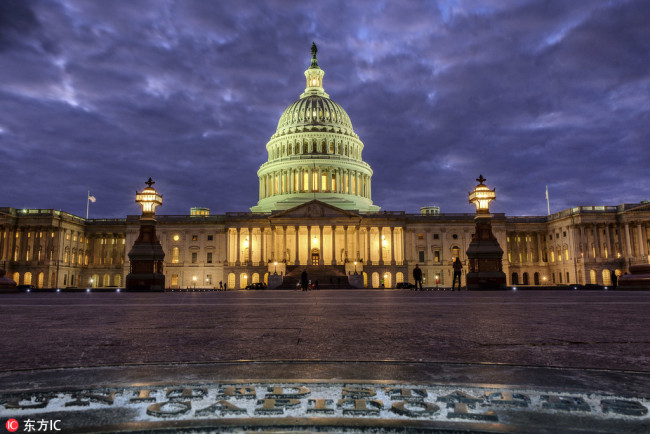 Lights shine inside the U.S. Capitol Building as night falls in Washington, Sunday, Jan. 21, 2018. [Photo: IC]