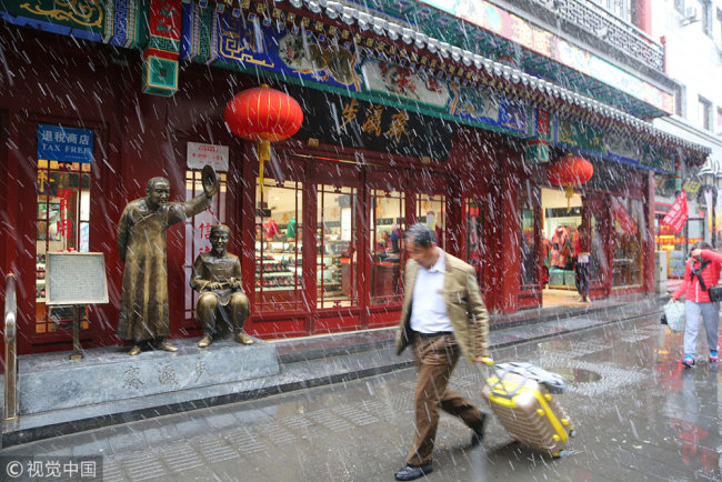 A man walks in the street in Beijing's Dashilanr sub-district. [Photo: VCG] 