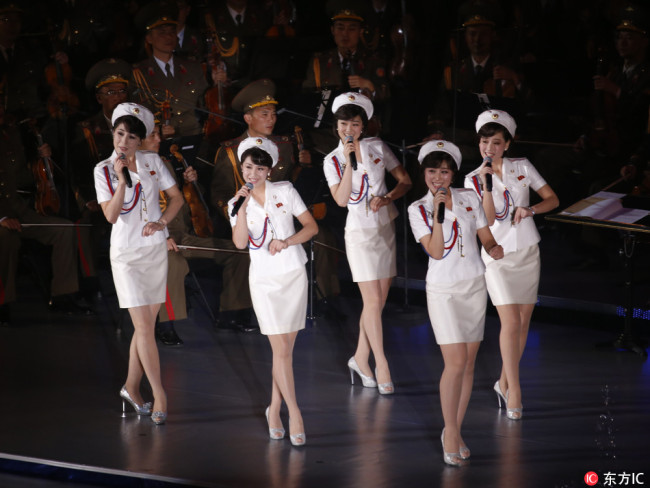 Members of North Korea's Moranbong band sing and dance during a joint performance with the State Merited Chorus in Pyongyang, North Korea, Sunday, Oct. 11, 2015. The performance was part of the 70th anniversary celebrations of the founding of the ruling Workers' Party.[File Photo: IC]
