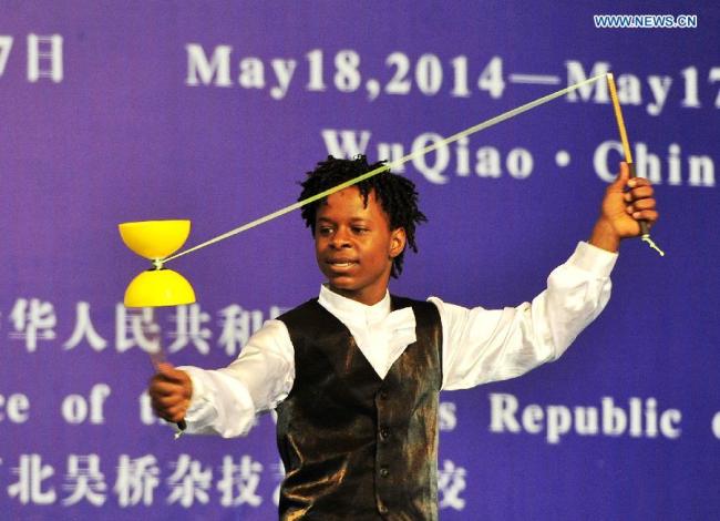 An African student performs acrobatics on the commencement of their course in Cangzhou, north China's Hebei Province, May 13, 2015. [Photo: Xinhua]