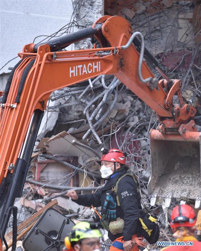 Rescuers work in front of a collapsed building in quake-hit Hualien County, southeast China's Taiwan, Feb. 7, 2018. [Photo: Xinhua]