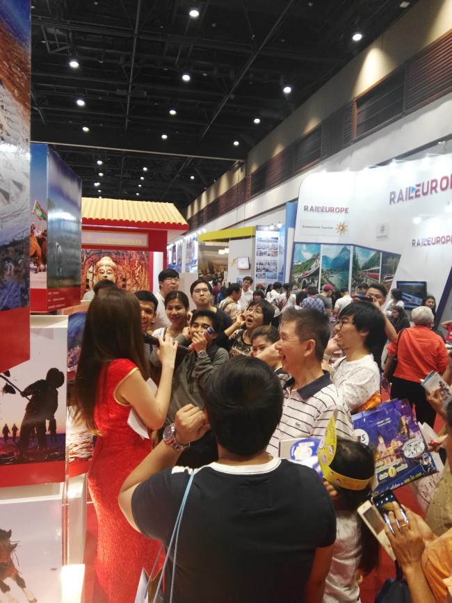 Visitors watch a Chinese art performance during the 22nd Thai International Travel Fair