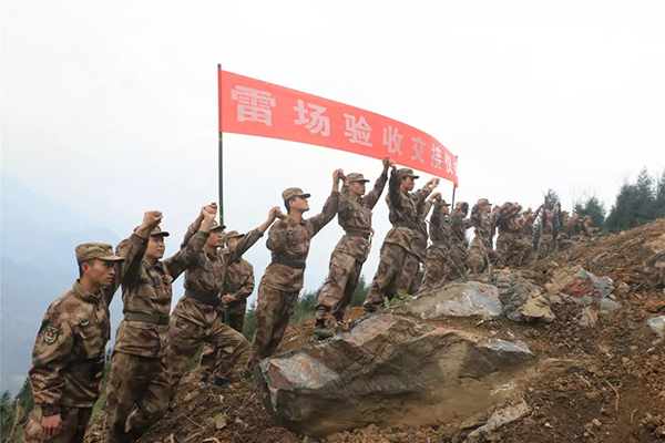 A group of soldiers walk on a recently-cleared mine field in Yunnan Province. [Photo: PLA Daily]