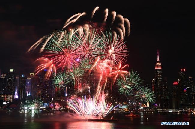 Photo taken on Feb. 14, 2018 from Weehawken of New Jersey, the United States, shows the fireworks over Manhattan of New York City celebrating the Chinese Lunar New Year. [Photo: Xinhua/Li Rui]