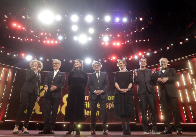 Festival director Dieter Kosslick, right, poses with the jury, from right, Tom Tykwer, Cecile de France, Chema Prado, Adele Romanski, Ryuichi Sakamoto and Stephanie Zacharek during opening of the 68th edition of the International Film Festival Berlin, Berlinale, in Berlin, Germany, Thursday, Feb. 15, 2018. [Photo: AP/Markus Schreiber] 