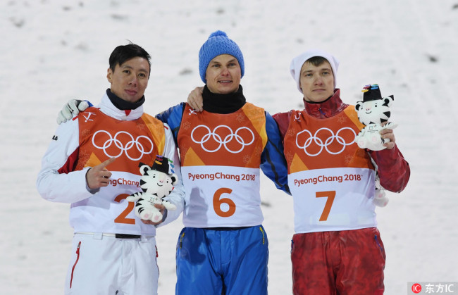 Medalists from left Jia Zongyang, Oleksandr Abramenko and Ilia Burov at the venue victory ceremony after the men's freestyle skiing aerials final during the Pyeongchang 2018 Olympic Winter Games at Phoenix Snow Park. [Photo: IC]