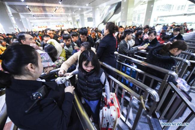 Passengers enter Guiyang Railway Station in Guiyang, capital of southwest China's Guizhou Province, Feb. 21, 2018. Passenger numbers are expected to grow on Wednesday, the last day of week-long Chinese Lunar New Year holiday. [Photo: Xinhua/Tao Liang]