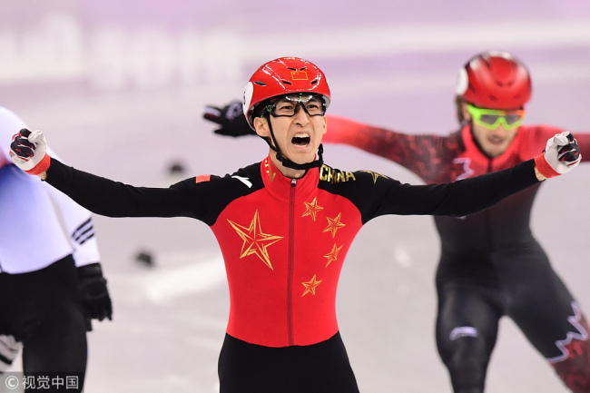 China's Wu Dajing celebrates gold at the finish line in the men's 500m short track speed skating A final event during the Pyeongchang 2018 Winter Olympic Games, at the Gangneung Ice Arena in Gangneung on February 22, 2018. [Photo: VCG]