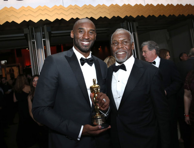 Kobe Bryant, winner of the award for best animated short for "Dear Basketball", left, and Danny Glover attend the Governors Ball after the Oscars on Sunday, March 4, 2018, at the Dolby Theatre in Los Angeles. [Photo by Eric Jamison/Invision/AP]