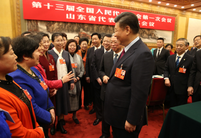 On Women's Day, President Xi Jinping talks with female deputies from Shandong Province who are in Beijing for the 13th National People's Congress (NPC). [Photo: Xinhua/Yao Dawei]