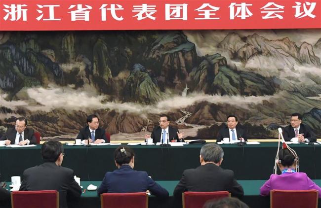 Chinese Premier Li Keqiang, who is also a member of the Standing Committee of the Political Bureau of the Communist Party of China (CPC) Central Committee, joins a panel discussion with the deputies from Zhejiang Province at the first session of the 13th National People's Congress in Beijing, capital of China, March 7, 2018. [Photo: Xinhua/Rao Aimin]