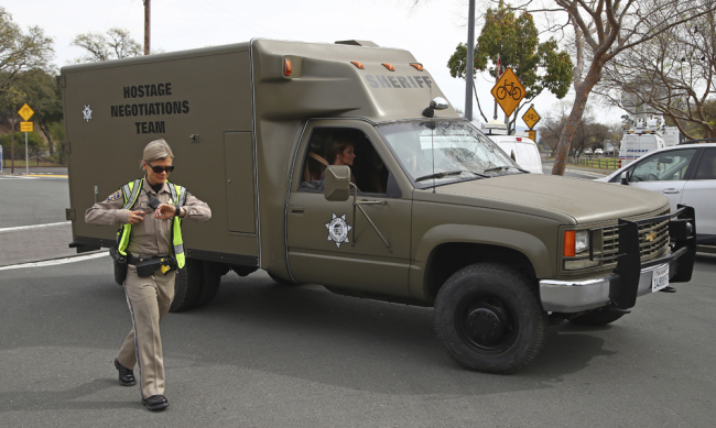 A sheriff's hostage negotiation team passes a California highway patrol checkpoint at the Veterans Home of California in Yountville, Calif., Friday, March 9, 2018. Napa County Fire Capt. Chase Beckman says a gunman has taken hostages at the veterans home. Police closed access to the large veterans home after a man with a gun was reported on the grounds. [Photo: AP]