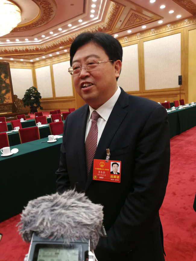 Li Chunkui, a deputy from the municipality of Chongqing for the 13th National People's Congress (NPC) is interviewed by journalists on March 10, 2018. [Photo: China Plus]
