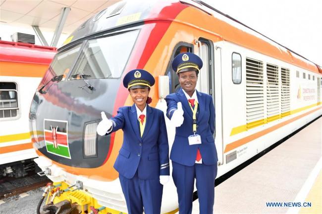 Two female engine drivers gesture before the operations of the Standard Gauge Railway (SGR) in Mombasa, Kenya, on May 31, 2017. Kenya began operations on the Chinese-built Standard Gauge Railway (SGR) on May 31, 2017. [Photo: Xinhua]