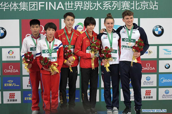 Gold medalists China's Lian Junjie(3rd L)/Lin Shan (3rd R), silver medalists Hyon Il Myong(1st L)/Kim Mi Hwa (2nd L) of the Democratic People's Republic of Korea (DPRK) and bronze medalists Britain's Matthew Lee (1st R)/Lois Toulson pose during the awarding ceremony for the mixed 10m synchronized event at the FINA Diving World Series 2018 in Beijing, capital of China, on March 11, 2018. [Photo: Xinhua/He Changshan]