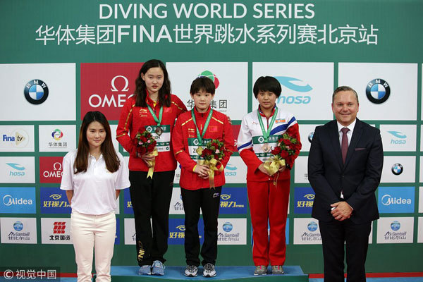 Gold medalist Zhang Jiaqi of China (Center), silver medalist Ren Qian of China (2nd left) and bronze medalist Kim Kuk Hyang of the Democratic People's Republic of Korea (DPRK), pose for photos during the awarding ceremony of women's 10m platform event at the FINA Diving World Series 2018 in Beijing on March 11, 2018. [Photo: VCG]