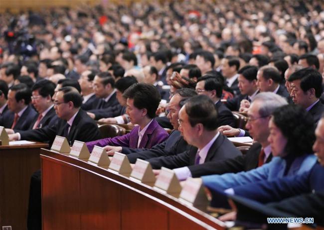 Deputies to the 13th National People's Congress (NPC) press buttons to vote at the fifth plenary meeting of the first session of the 13th NPC at the Great Hall of the People in Beijing, capital of China, March 17, 2018. [Photo: Xinhua/Liu Weibing]