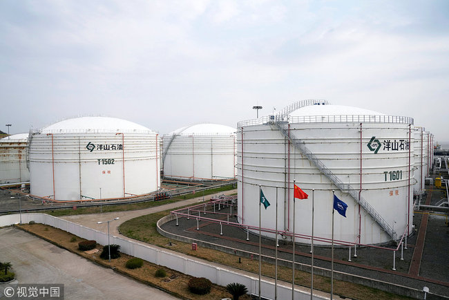 Oil tanks are seen at an oil warehouse at Yangshan port in Shanghai, China March 14, 2018. [Photo: VCG]