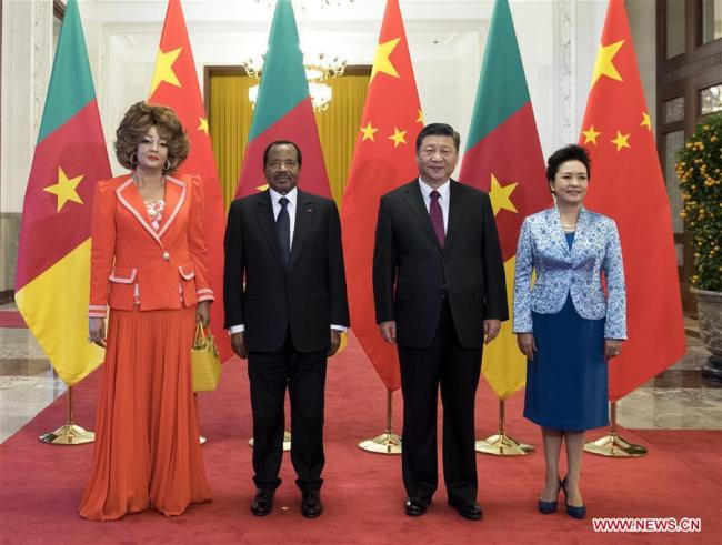 Chinese President Xi Jinping (2nd R) and his wife Peng Liyuan (1st R) pose for a photo with visiting Cameroonian President Paul Biya (2nd L) and his wife in Beijing, capital of China, March 22, 2018. Xi Jinping held talks with his Cameroonian counterpart Paul Biya at the Great Hall of the People in Beijing Thursday. [Photo: Xinhua/Li Xueren]