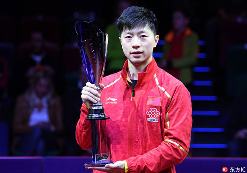Chinese table tennis athlete Ma Long holds the trophy in his hand after winning the men's singles title at the ITTF World Tour German Open on March 25, 2018. [Photo: Imagine China]