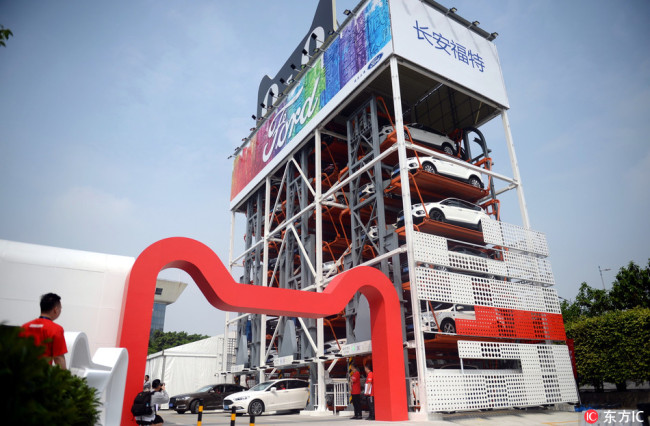 China's first "car vending machine" store launched by the online shopping site Tmall.com of Chinese e-commerce giant Alibaba Group is pictured in Guangzhou city, south China's Guangdong province, 26 March 2018.