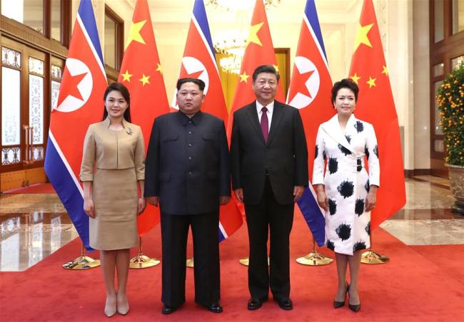 Xi Jinping (2nd R), general secretary of the Central Committee of the Communist Party of China (CPC) and Chinese president, and his wife Peng Liyuan (1st R) meet with Kim Jong Un (2nd L), chairman of the Workers' Party of Korea (WPK) and chairman of the State Affairs Commission of the Democratic People's Republic of Korea (DPRK), and his wife Ri Sol Ju at the Great Hall of the People in Beijing, capital of China. At the invitation of Xi, Kim paid an unofficial visit to China from March 25 to 28. During the visit, Xi held talks with Kim. [Photo: Xinhua/Ju Peng]