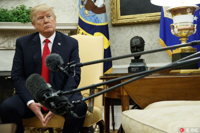 President Donald Trump listens to a question during a meeting with Swedish Prime Minister Stefan Lofven in the Oval Office of the White House, Tuesday, March 6, 2018, in Washington.[Photo: IC]