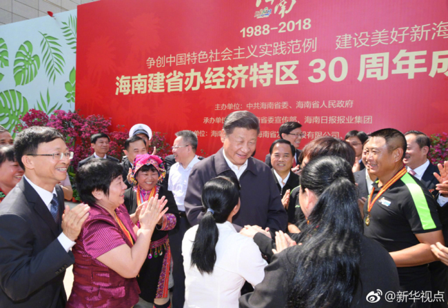 Chinese President Xi Jinping shakes hands with locals in Haikou, capital city of Hainan Province, on April 13. [Photo: Xinhua]