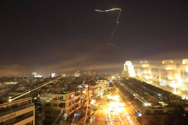 Damascus skies erupt with anti-aircraft fire as the U.S. launches an attack on Syria targeting different parts of the Syrian capital Damascus, Syria, early Saturday, April 14, 2018. [Photo: AP/Hassan Ammar]